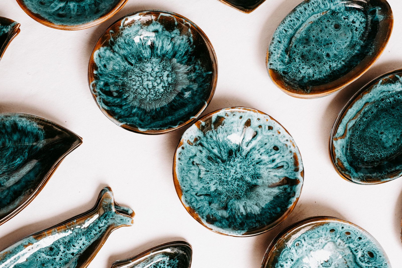 Close view of turquoise glazed ceramic bowls showing the depth and flow of the glaze