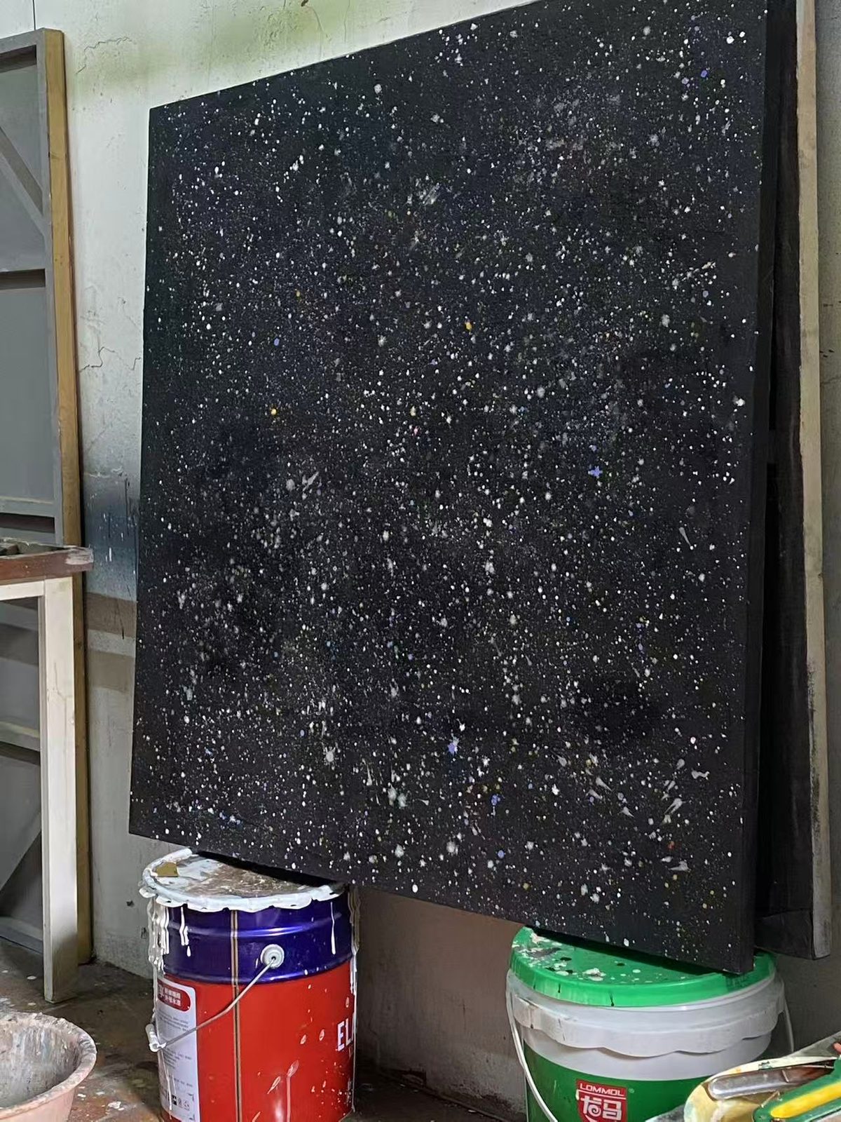 Dark abstract panel standing in the studio