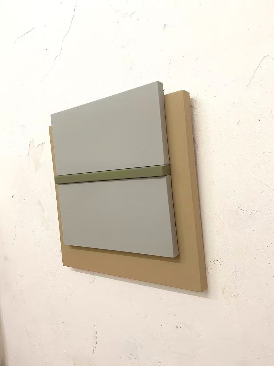 Studio shelves with a framed work